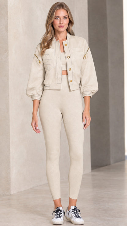 Model wearing beige cropped utility jacket with snap front and contrast details