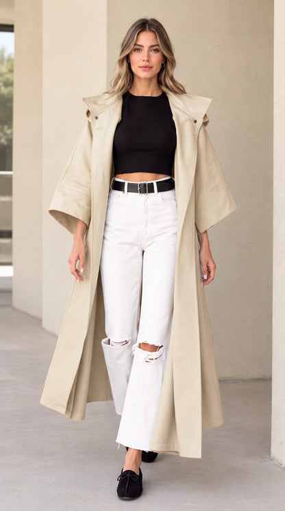 Front view of woman wearing beige hooded maxi duster coat